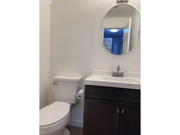 a bathroom with a sink vanity and toilet