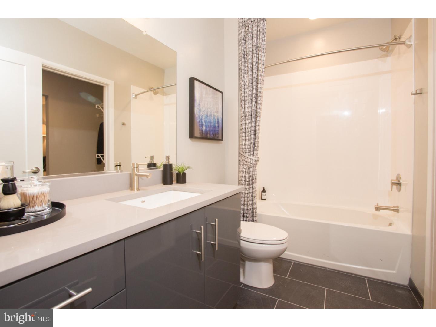 121 North 2nd Street, Unit 214 Philadelphia, PA 19106 - Photo 15 of 17 a bathroom with a double vanity sink toilet and a mirror