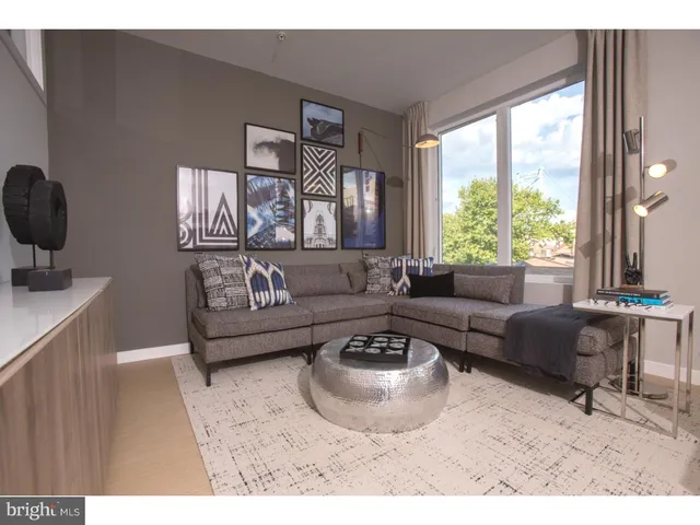 a living room with furniture and a large window