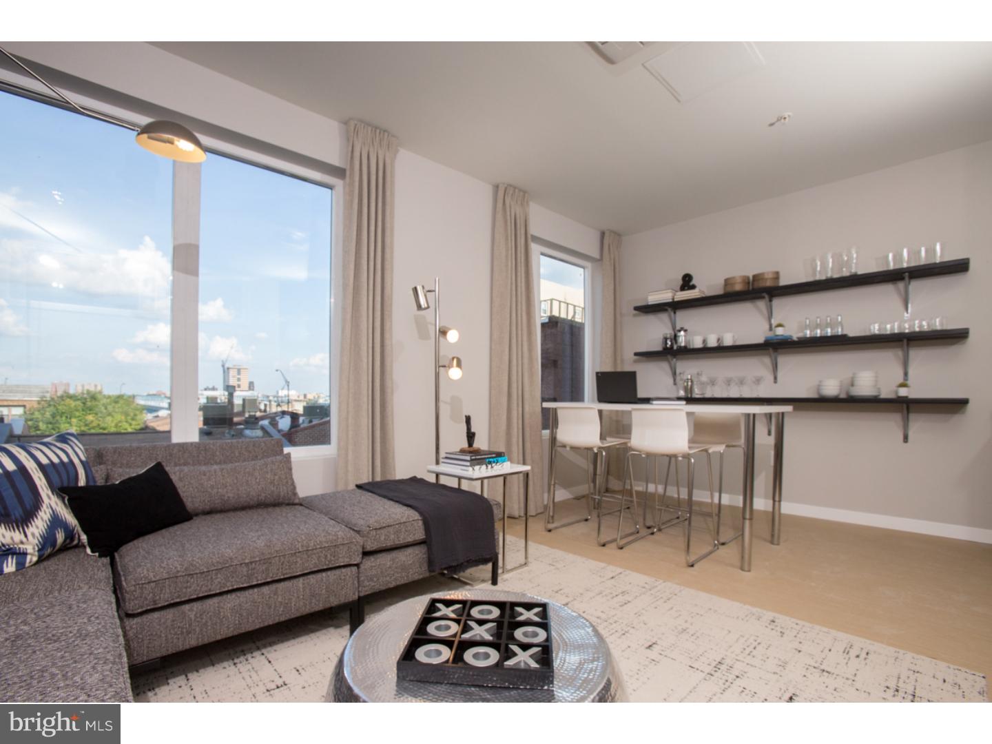121 North 2nd Street, Unit 214 Philadelphia, PA 19106 - Photo 3 of 17 a living room with furniture and a large window
