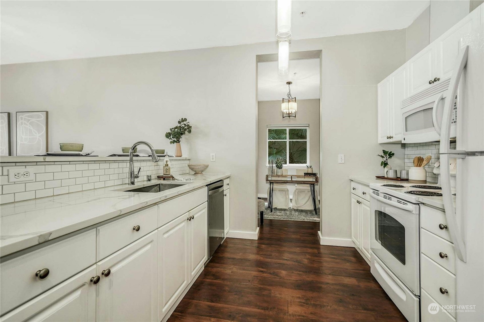 17426 Bothell Way Northeast, Unit A305 Bothell, WA 98011 - Photo 12 of 38 a kitchen with granite countertop white cabinets and white appliances