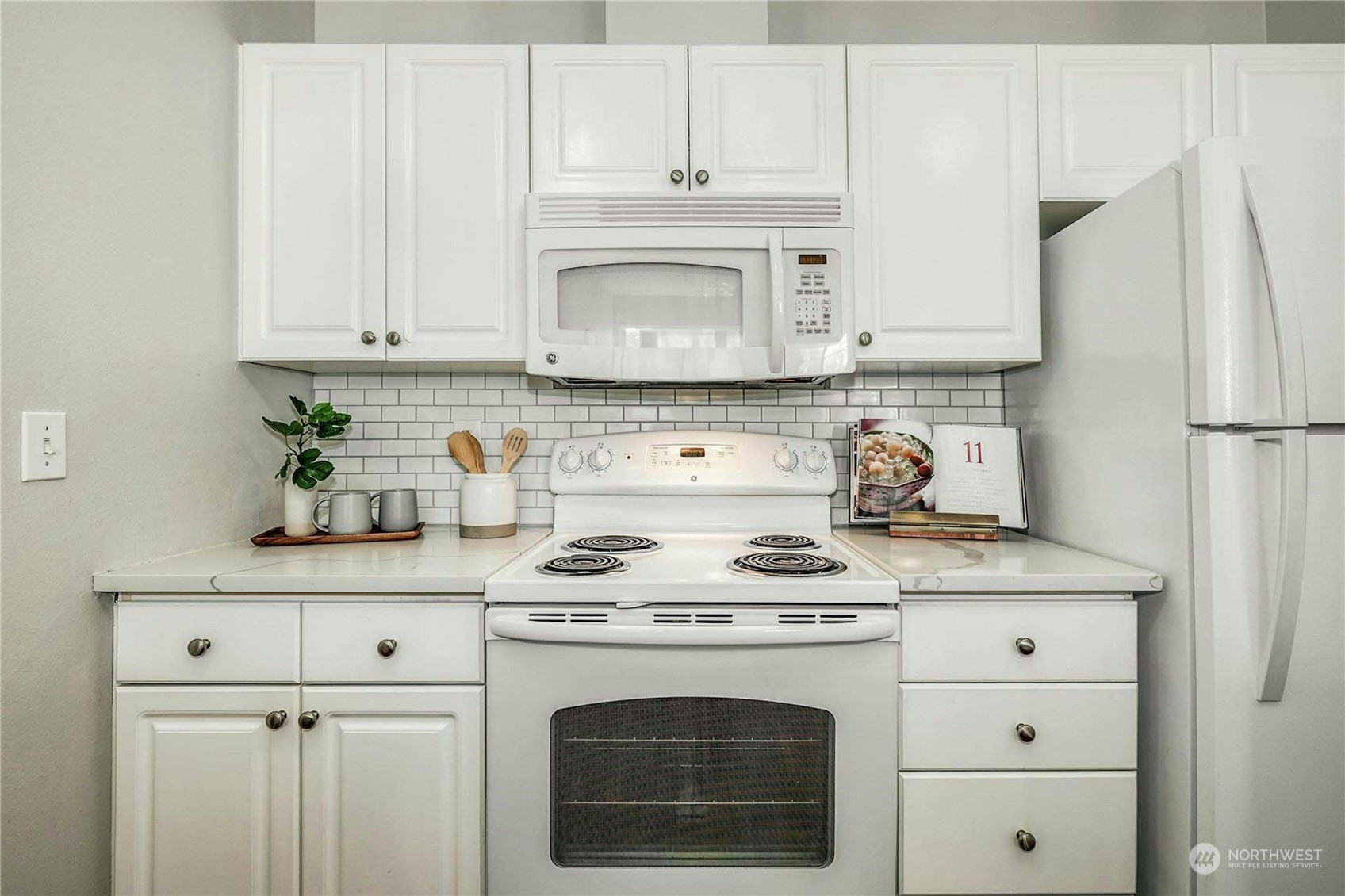 17426 Bothell Way Northeast, Unit A305 Bothell, WA 98011 - Photo 13 of 38 a kitchen with cabinets appliances a sink and a counter