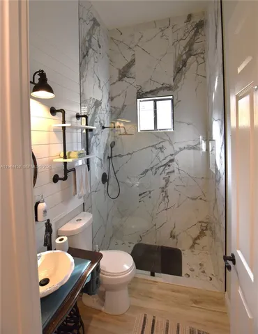 a view of a livingroom with a ceiling fan and window