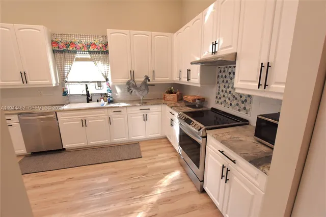 a bathroom with a double vanity sink mirror and shower