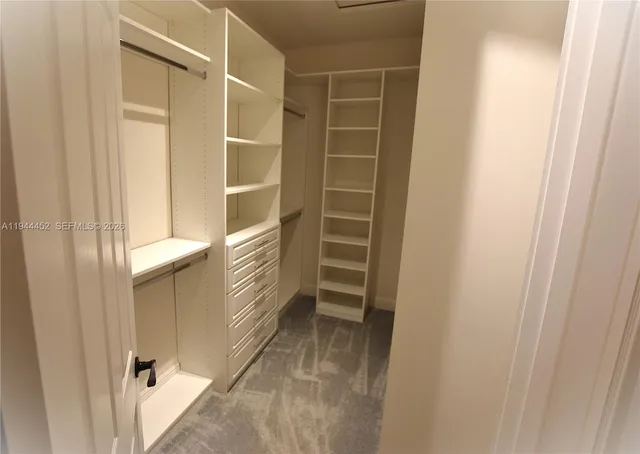 a view of a tennis ground with large trees