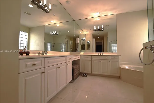 a view of swimming pool that has lawn chairs with plants and trees