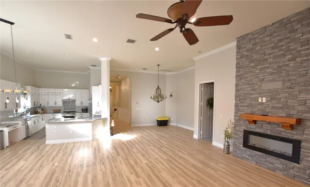 a view of a patio with a dining table and chairs with a fire pit and a yard