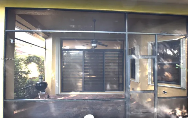 a living room with furniture and a floor to ceiling window
