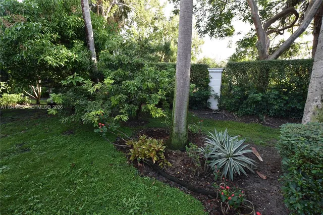 a living room with furniture a desk and a bookshelf