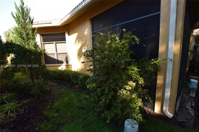 a living room with furniture a flat screen tv and a large window