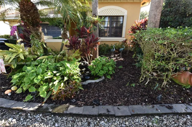 a front view of multi story residential apartment building with yard and green space