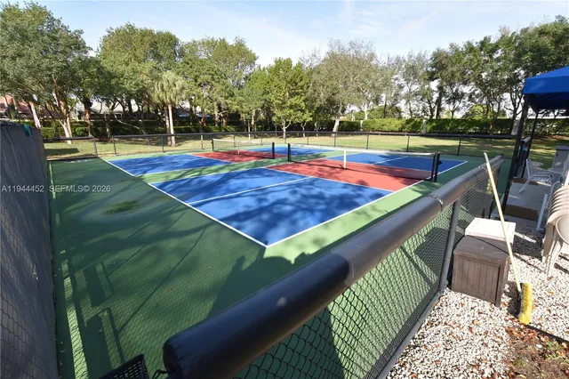 a view of a white house with a yard