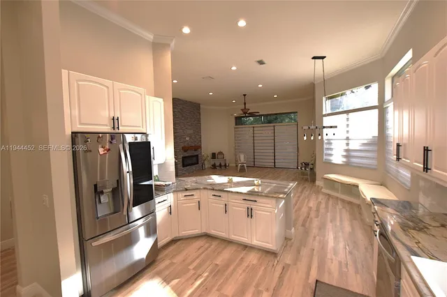 a view of a kitchen and dining room with wooden floor
