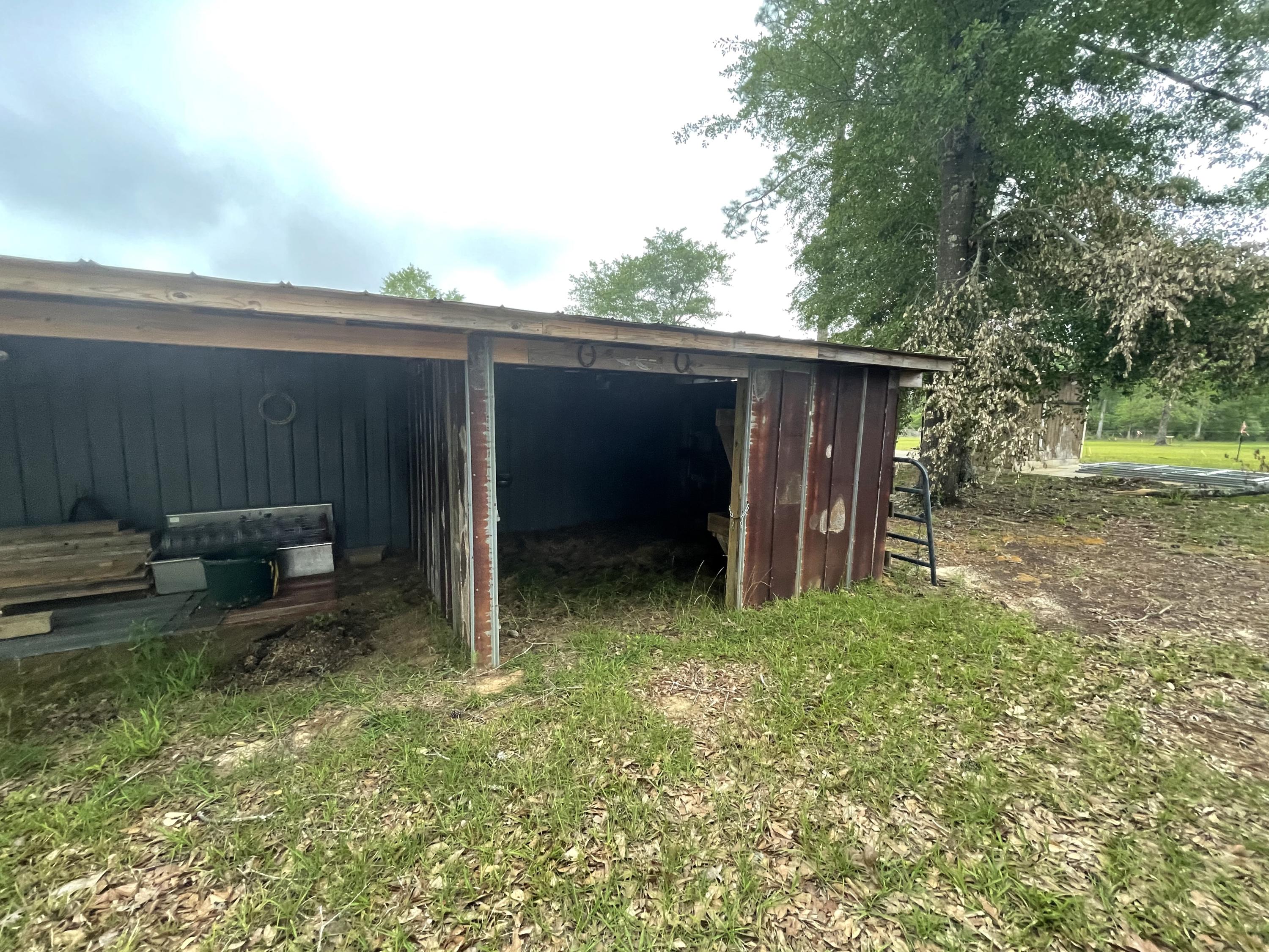 12.49-ac State Line Road Baker, FL 32531 - Photo 5 of 41 a backyard of a house with chairs and a table