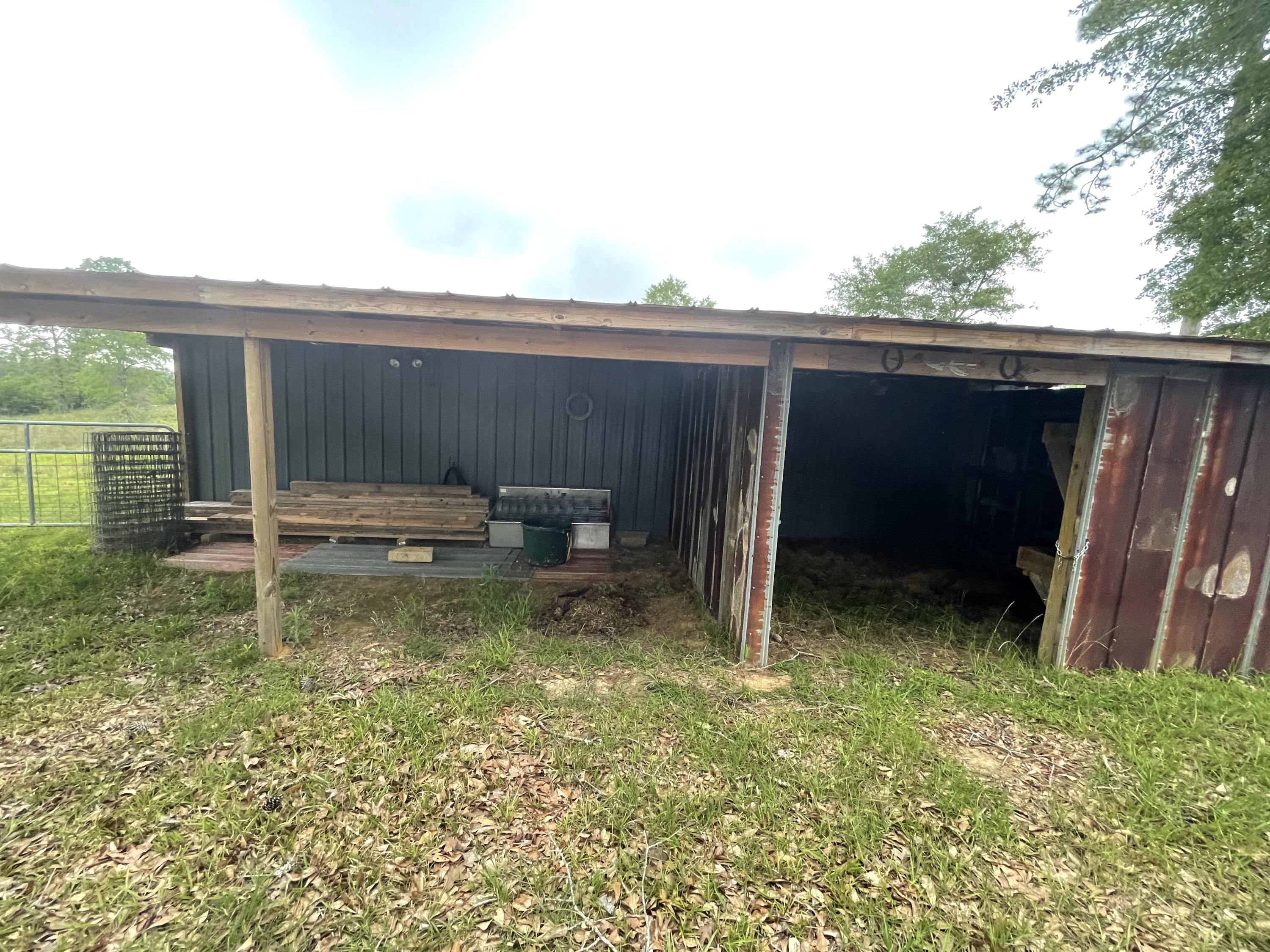 12.49-ac State Line Road Baker, FL 32531 - Photo 6 of 41 a backyard of a house with lawn chairs