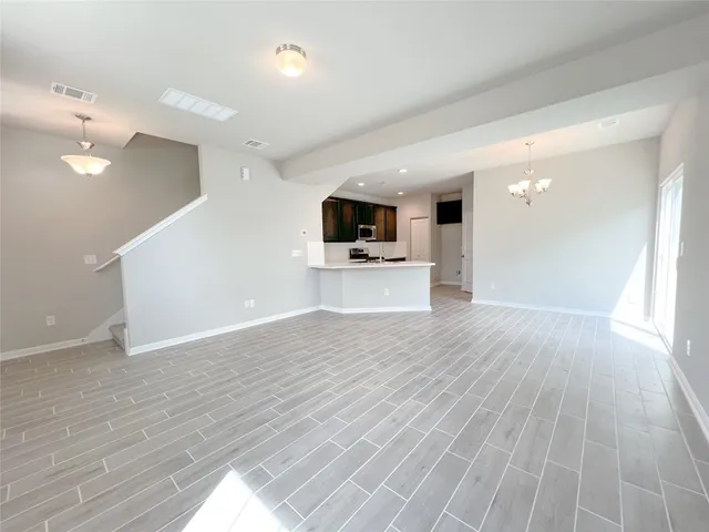 a view of a living room a flat screen tv and wooden floor