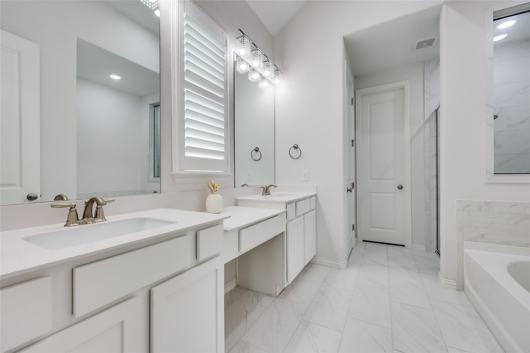 7705 Pace Ravine Drive Lago Vista, TX 78645 - Photo 16 of 40 Primary bathroom featuring a garden tub, light marble finish floors, double vanity, and a marble finish shower