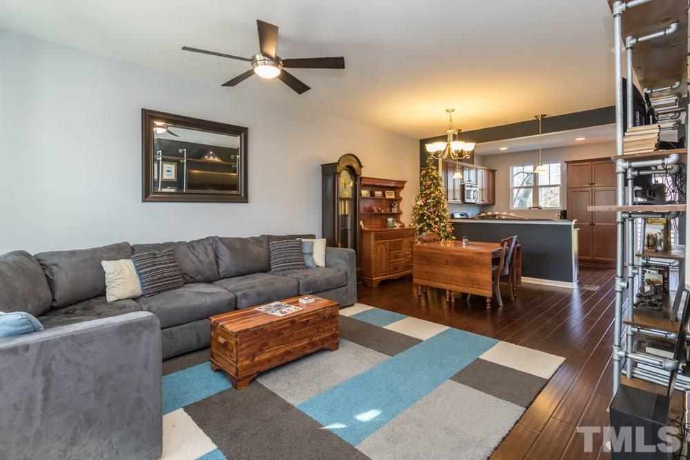 1619 Crafton Way Raleigh, NC 27607 - Photo 1 of 25 a living room with furniture a rug and a chandelier