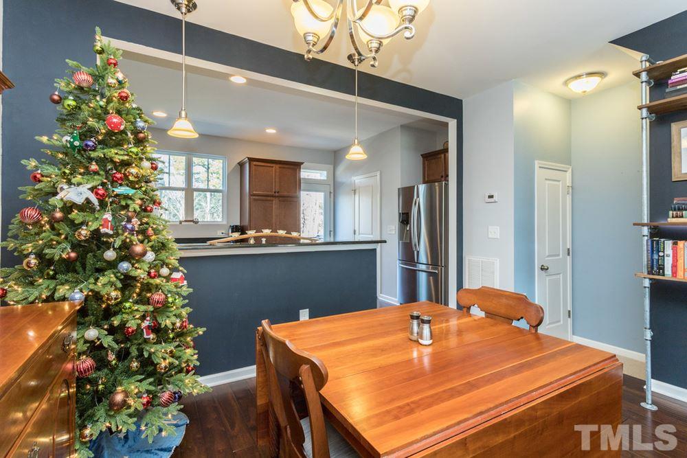 1619 Crafton Way Raleigh, NC 27607 - Photo 11 of 25 a kitchen with kitchen island a chandelier and refrigerator