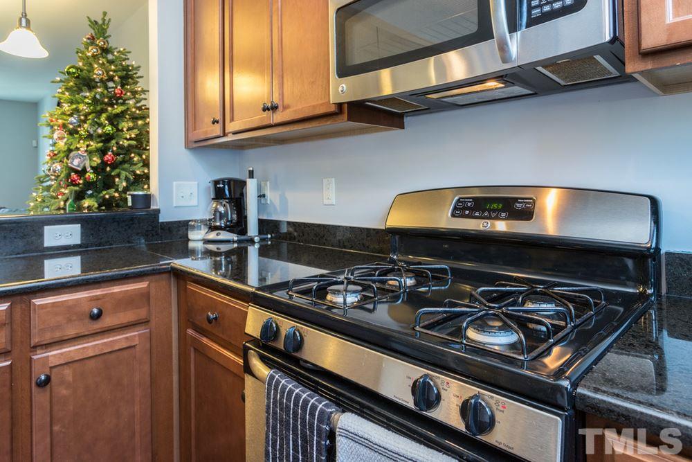 1619 Crafton Way Raleigh, NC 27607 - Photo 15 of 25 a kitchen with a stove and a microwave