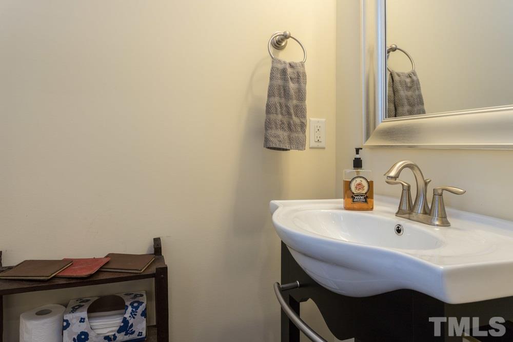 1619 Crafton Way Raleigh, NC 27607 - Photo 16 of 25 a bathroom with a sink and a mirror