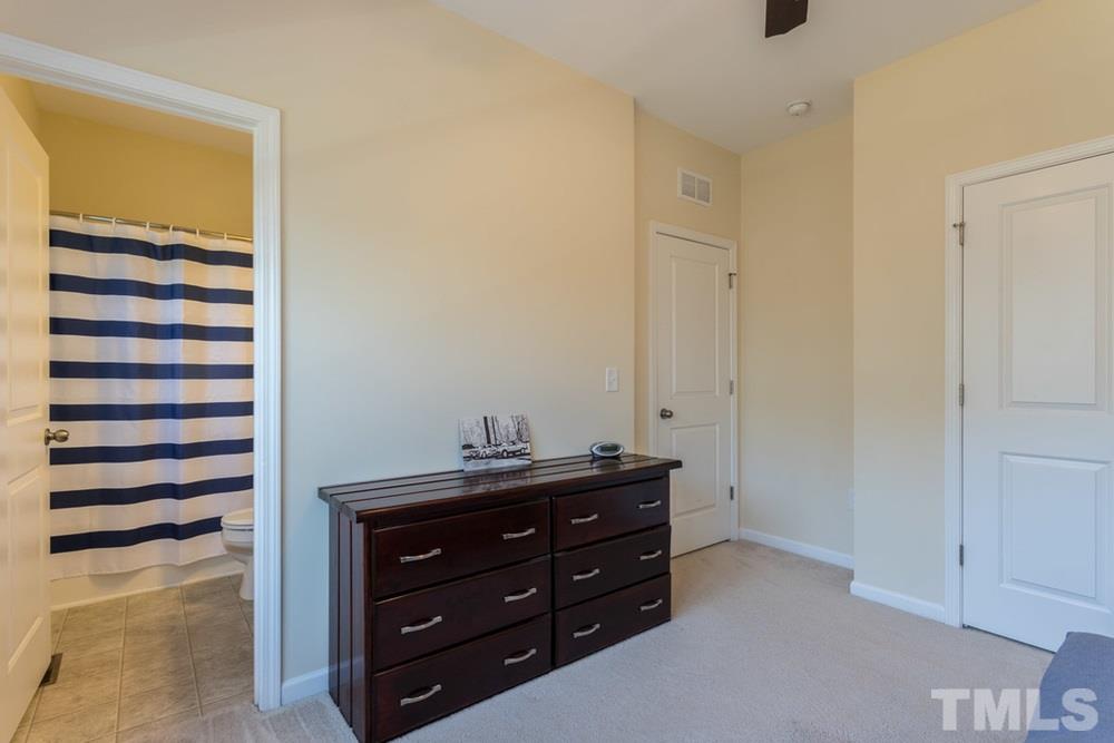 1619 Crafton Way Raleigh, NC 27607 - Photo 18 of 25 a room with a dresser and a mirror