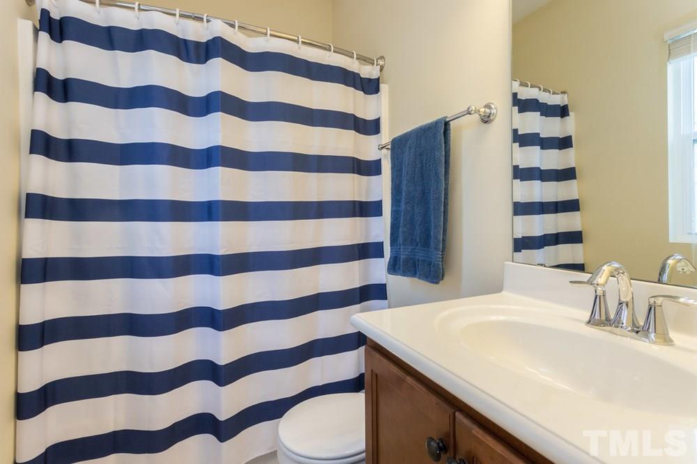 1619 Crafton Way Raleigh, NC 27607 - Photo 19 of 25 a bathroom with a sink and mirror