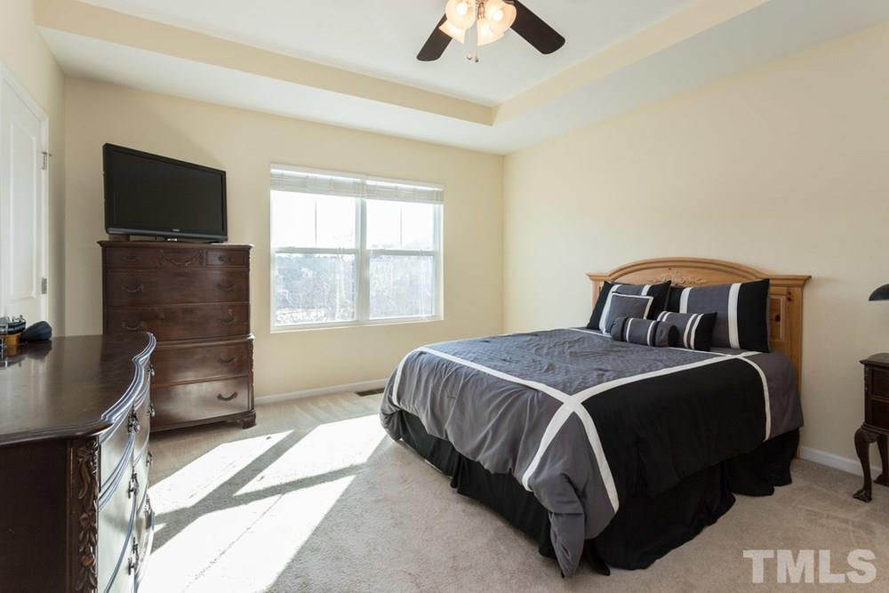 1619 Crafton Way Raleigh, NC 27607 - Photo 21 of 25 a bedroom with a bed and a television