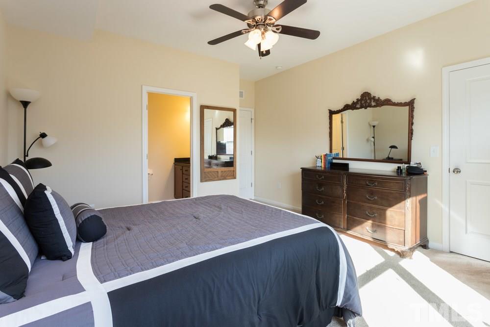 1619 Crafton Way Raleigh, NC 27607 - Photo 22 of 25 a bedroom with a bed and dresser