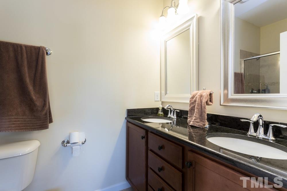 1619 Crafton Way Raleigh, NC 27607 - Photo 23 of 25 a bathroom with a granite countertop sink and a mirror