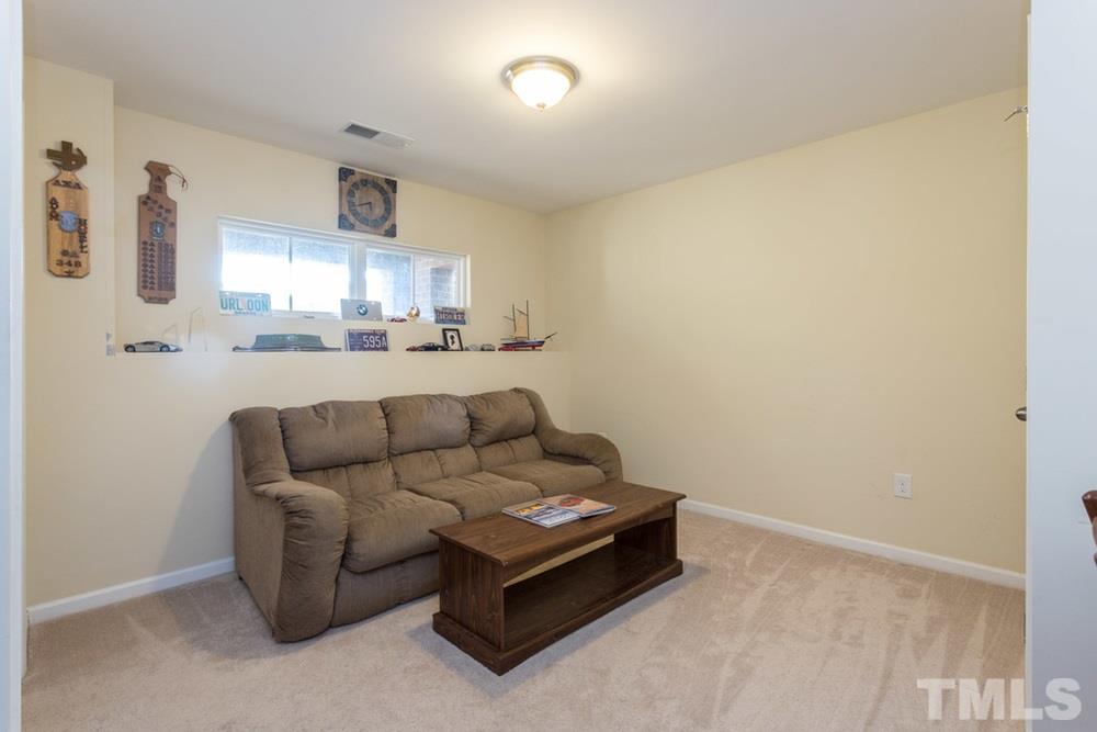 1619 Crafton Way Raleigh, NC 27607 - Photo 24 of 25 a living room with furniture and a night stand