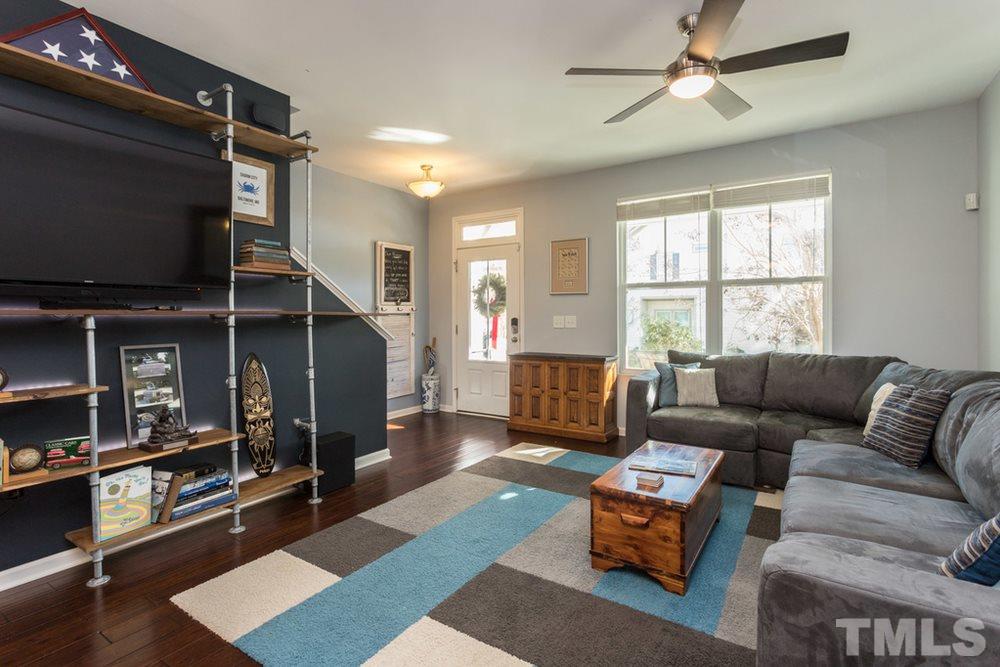 1619 Crafton Way Raleigh, NC 27607 - Photo 7 of 25 a living room with furniture a flat screen tv and a window