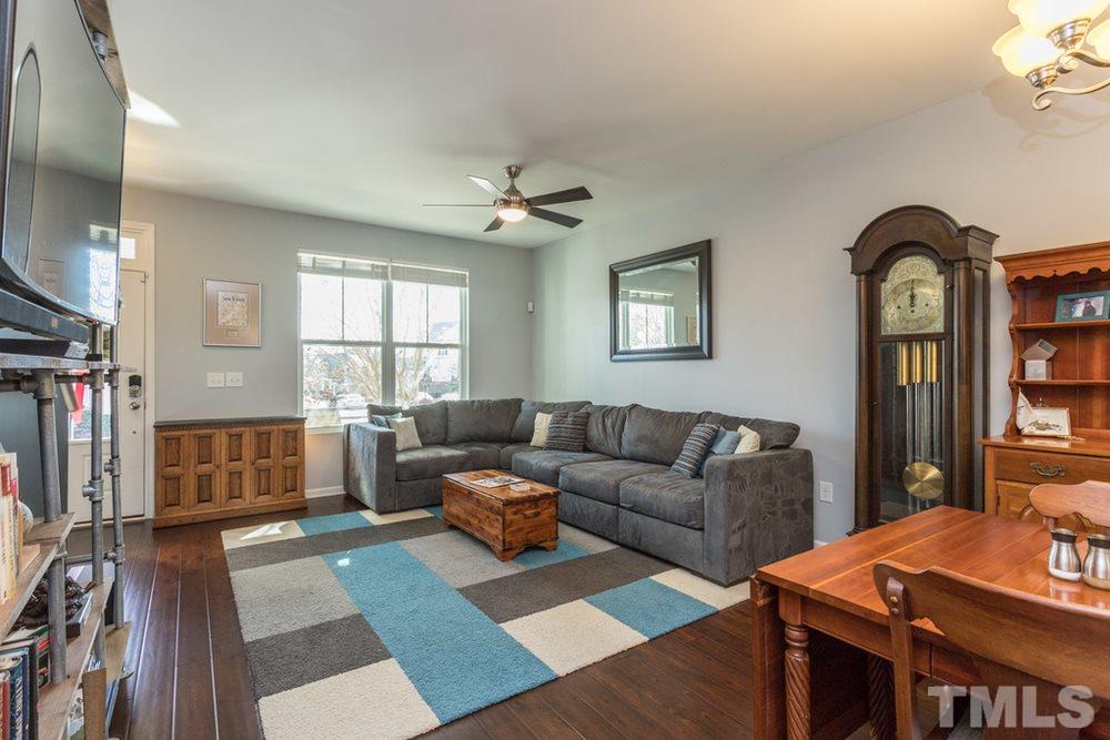 1619 Crafton Way Raleigh, NC 27607 - Photo 8 of 25 a living room with furniture a flat screen tv and a window
