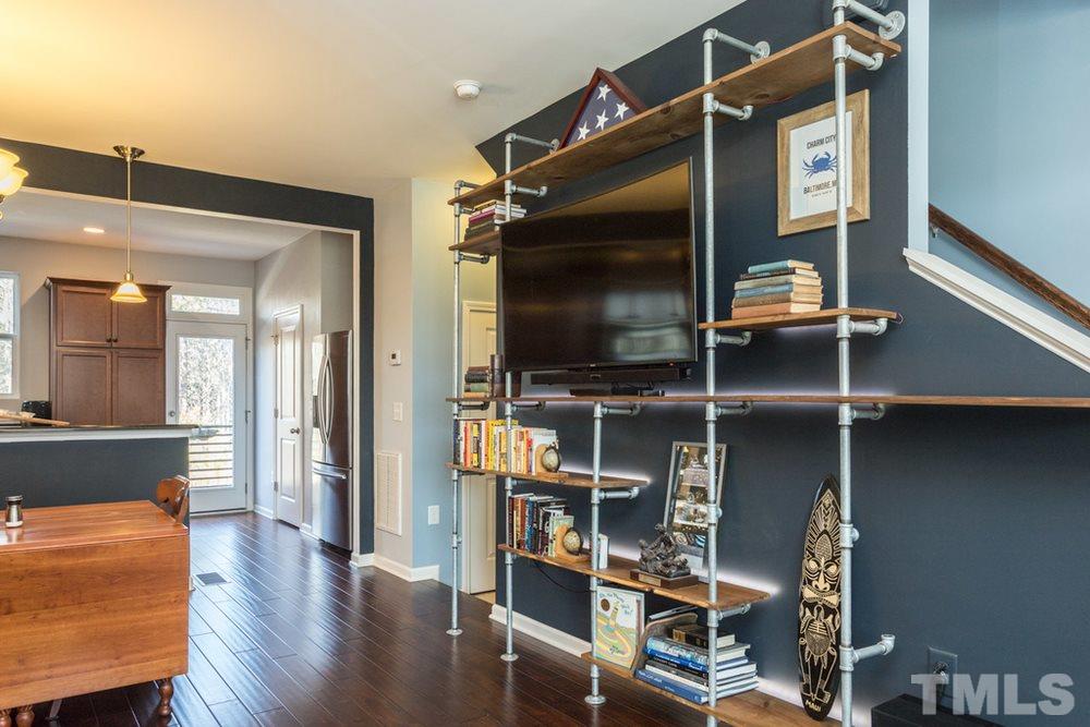 1619 Crafton Way Raleigh, NC 27607 - Photo 9 of 25 a living room with furniture and a flat screen tv