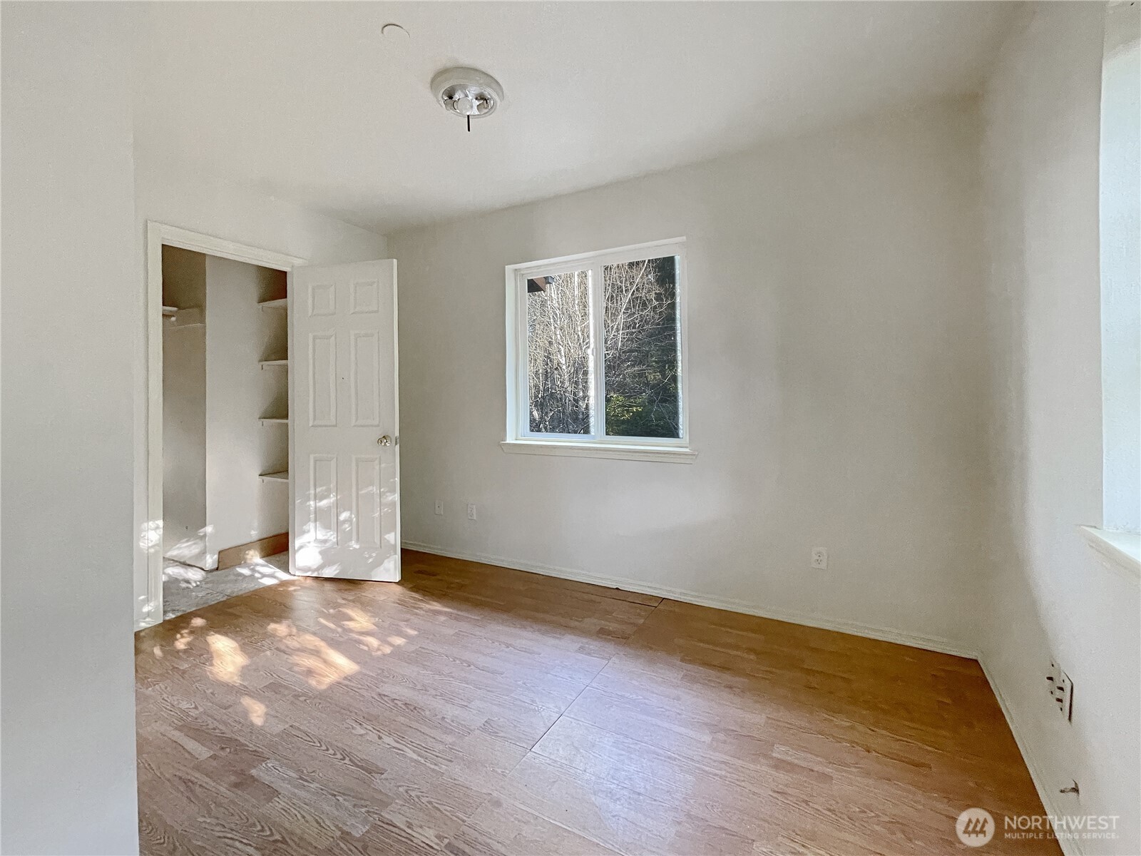 11 North Hamma Ridge Drive Lilliwaup, WA 98555 - Photo 29 of 40 an empty room with wooden floor and windows