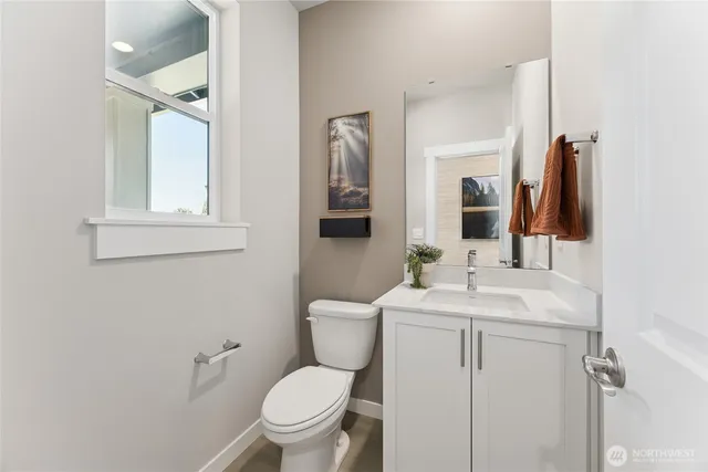 a bathroom with a toilet sink and mirror