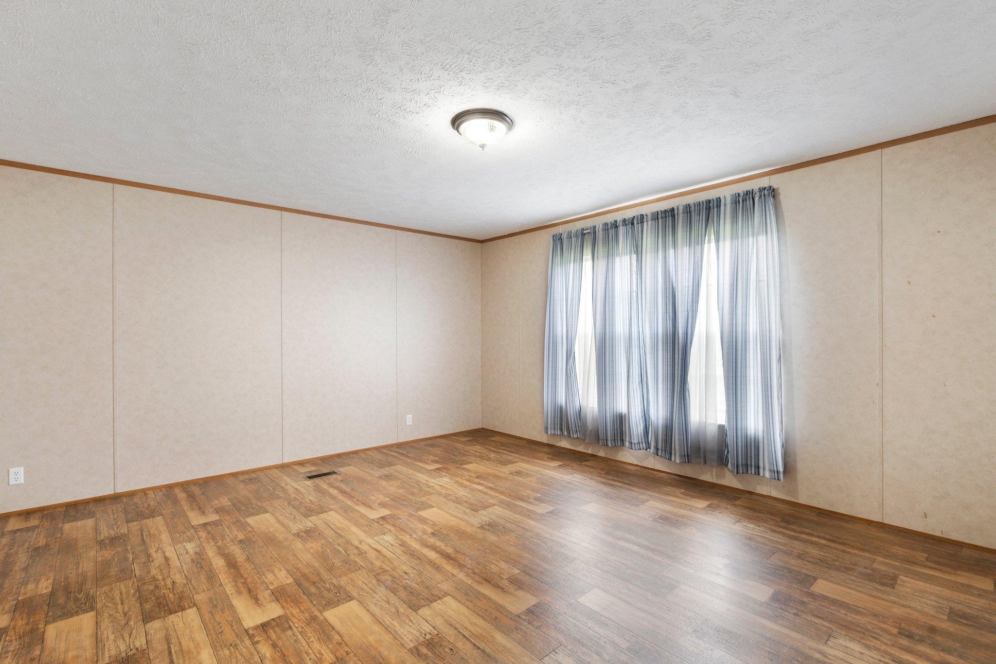 171 Buckner Road Philadelphia, TN 37846 - Photo 13 of 27 wooden floor in an empty room with a window