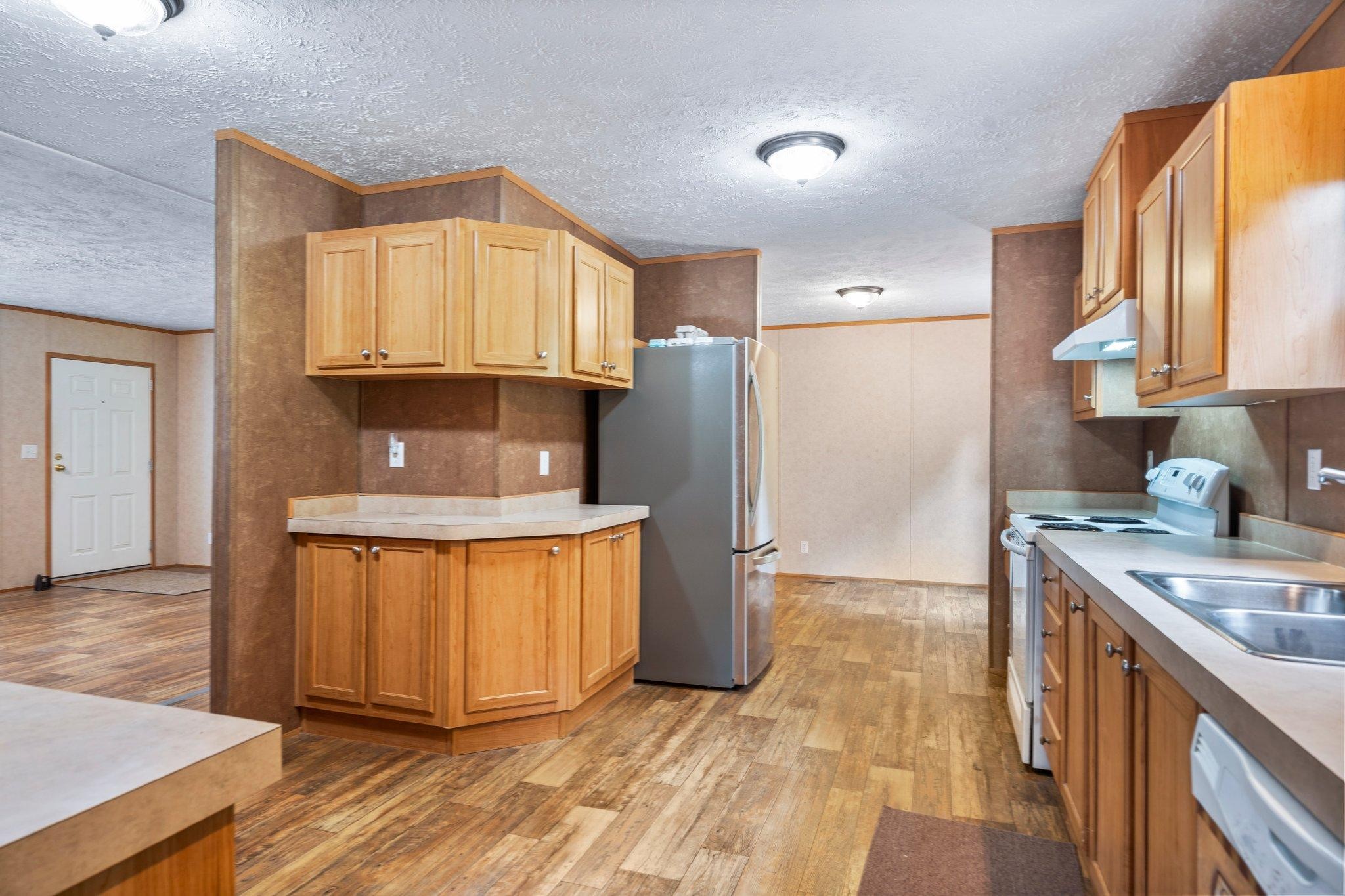 171 Buckner Road Philadelphia, TN 37846 - Photo 18 of 27 a kitchen with stainless steel appliances granite countertop a refrigerator a stove a sink and a white cabinets