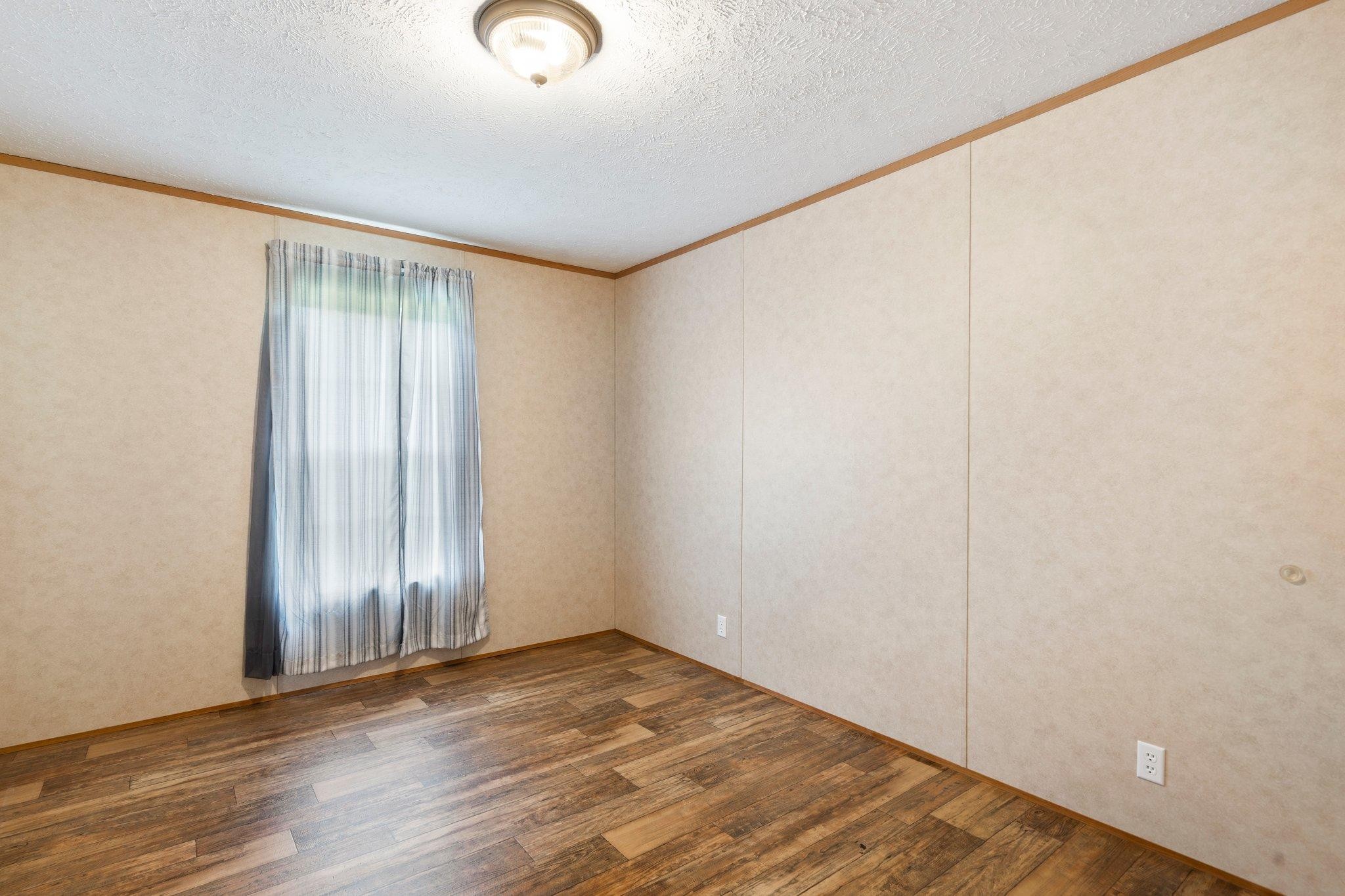 171 Buckner Road Philadelphia, TN 37846 - Photo 26 of 27 an empty room with wooden floor and windows