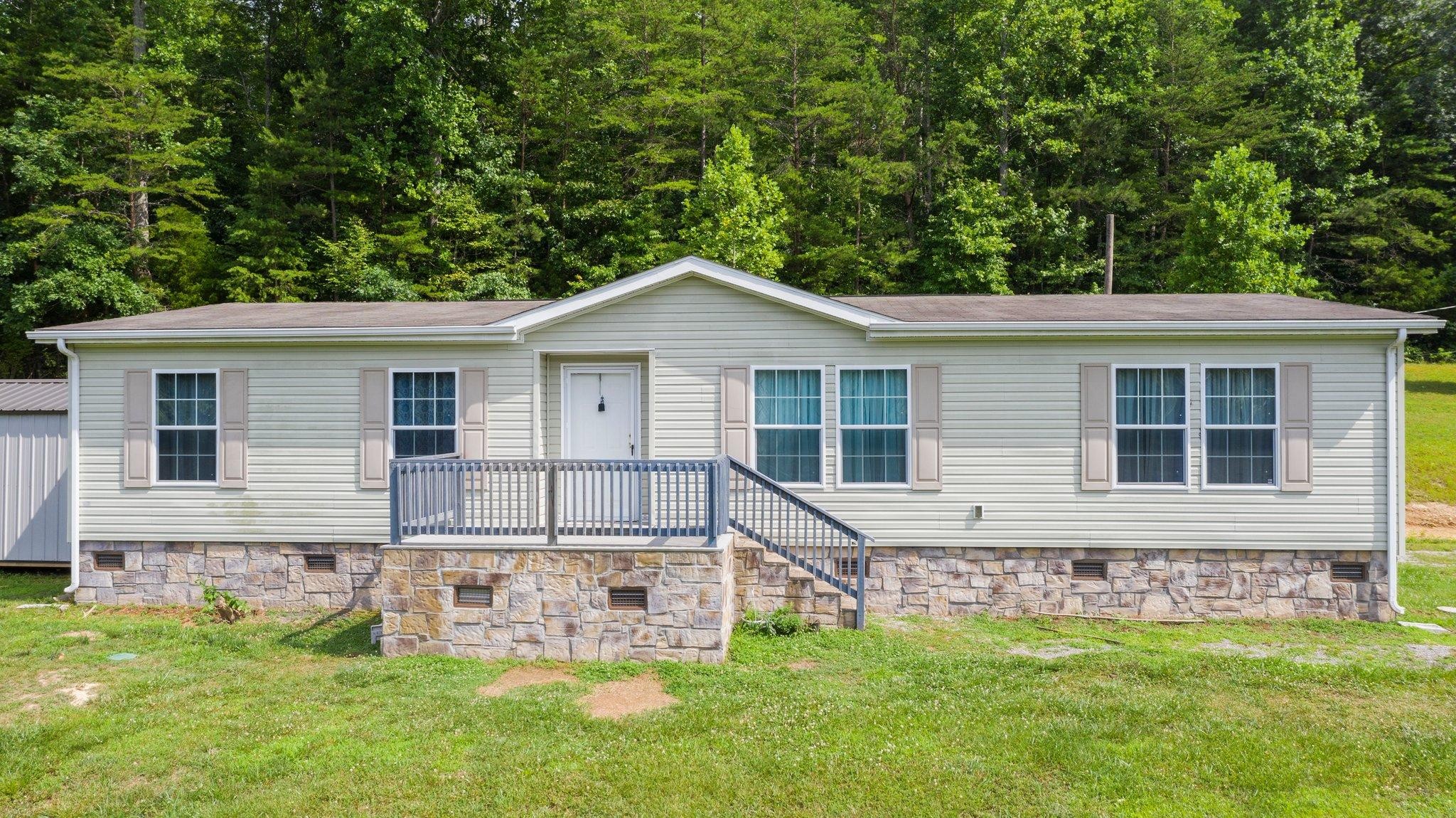 171 Buckner Road Philadelphia, TN 37846 - Photo 4 of 27 a view of a house with a backyard