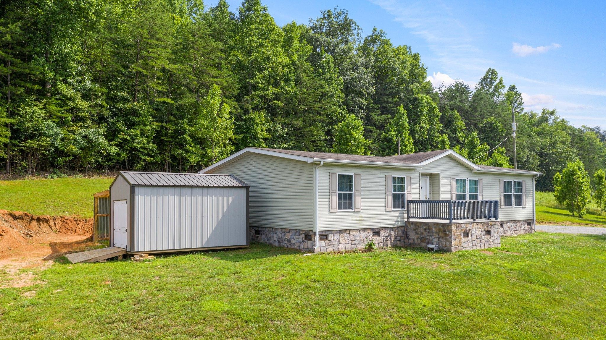 171 Buckner Road Philadelphia, TN 37846 - Photo 5 of 27 a view of a house with a backyard