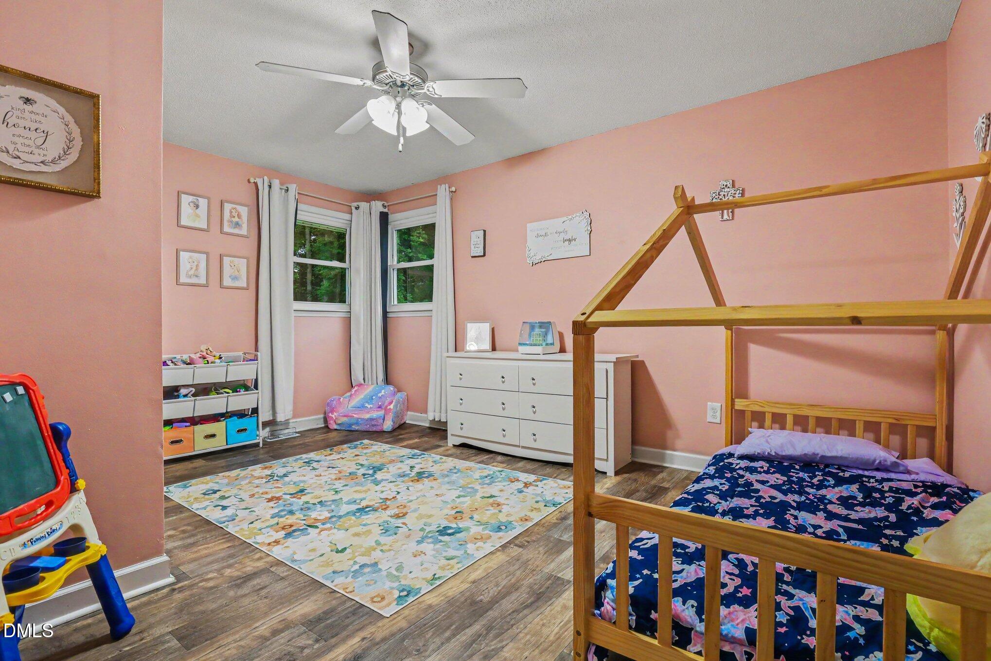 977 Stevens Mill Road Goldsboro, NC 27530 - Photo 23 of 31 a bedroom with a bed a large window and wooden floor
