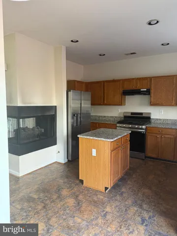 a kitchen with stainless steel appliances a stove a microwave a sink and a cabinets