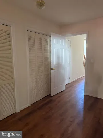 an empty room with wooden floor