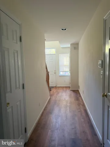 a view of a room with wooden floor and a window