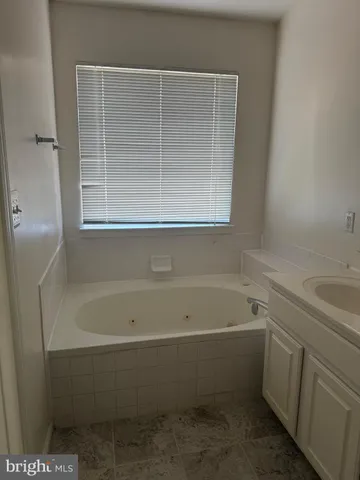 a bathroom with a bathtub and window