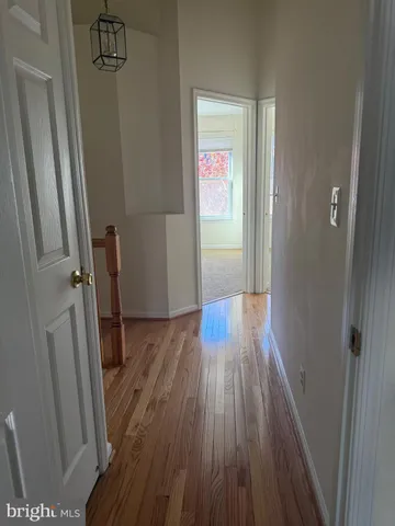 a view of hallway with wooden floor
