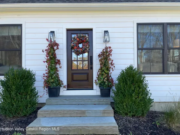 a front view of a house with plants