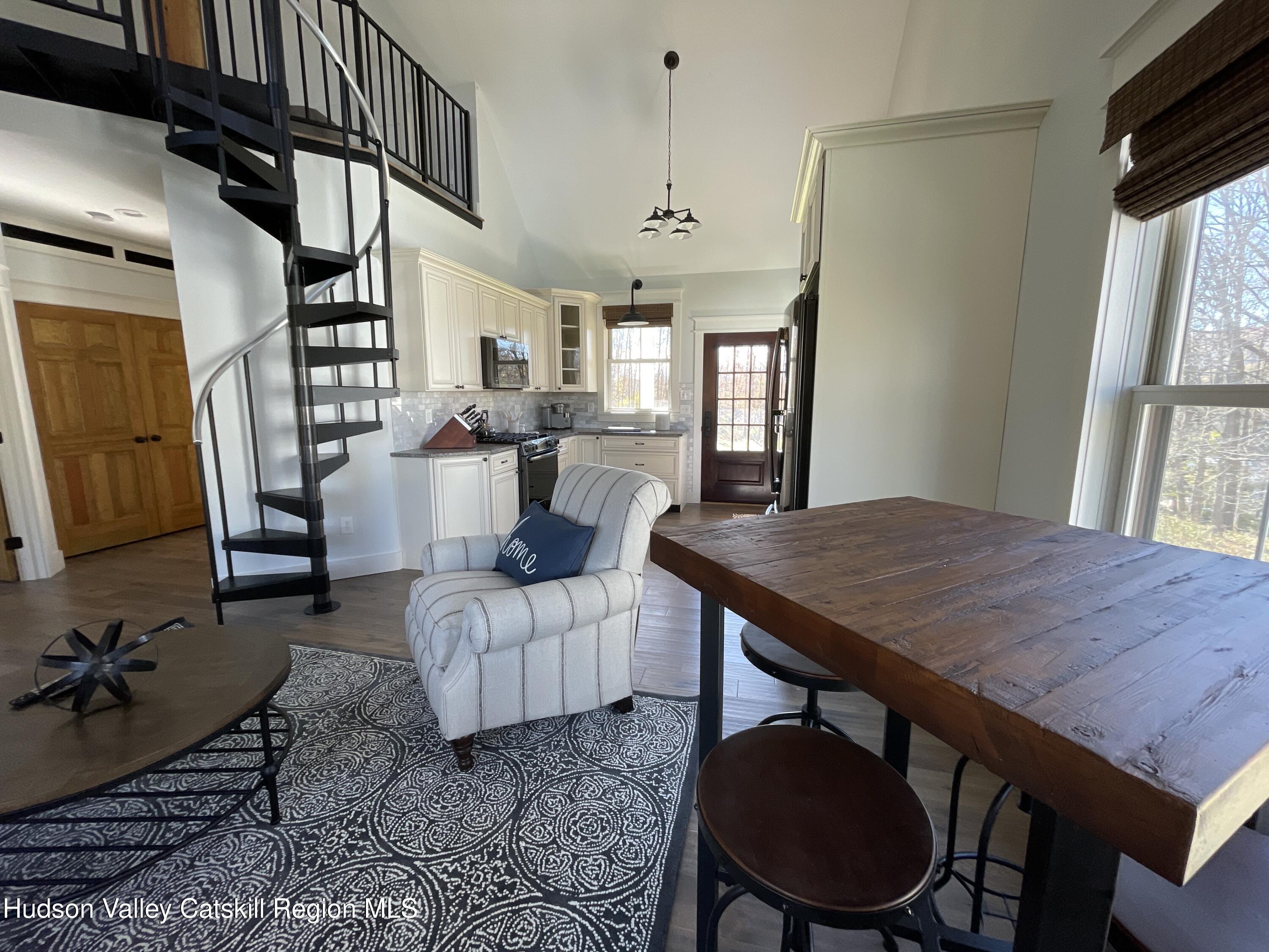 106 Beilke Road Millerton, NY 12546 - Photo 6 of 10 a living room with furniture a fireplace and a flat screen tv