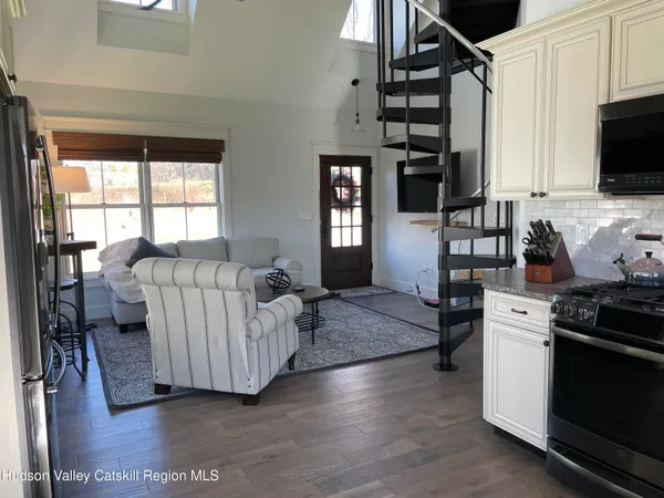 a living room with furniture and flat screen tv